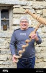 france-jura-chateau-chalon-winegrower-jean-pierre-salvadori-holding-a-giant-corkscrew-and-next...jpg